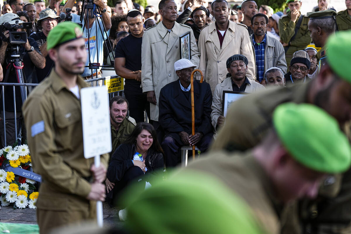 Family and friends of Staff Sergeant Aschalwu Sama mourn during his funeral in Petah Tikva, Isr ...