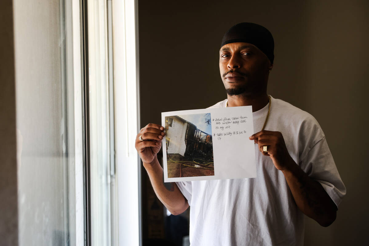 Jeremy Williams holds a photo he took with his phone of the aftermath of the June 6 Tides apart ...