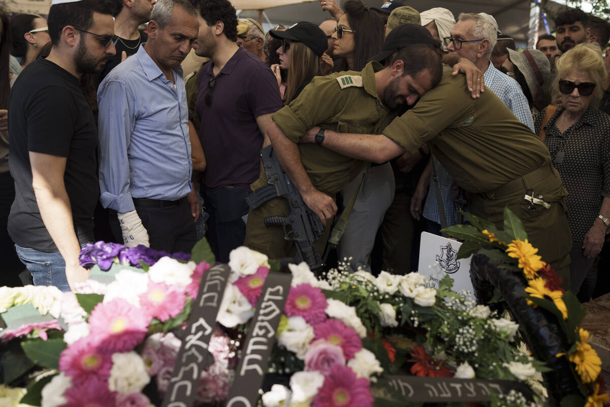 Relatives and friends of Israeli Col. Asaf Hamami mourn during his funeral at the Kiryat Shaul ...