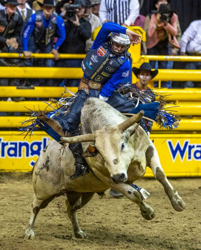 Stetson Wright of Milford, Utah, rides Pookie Holler to a winning score in Bull Riding during t ...