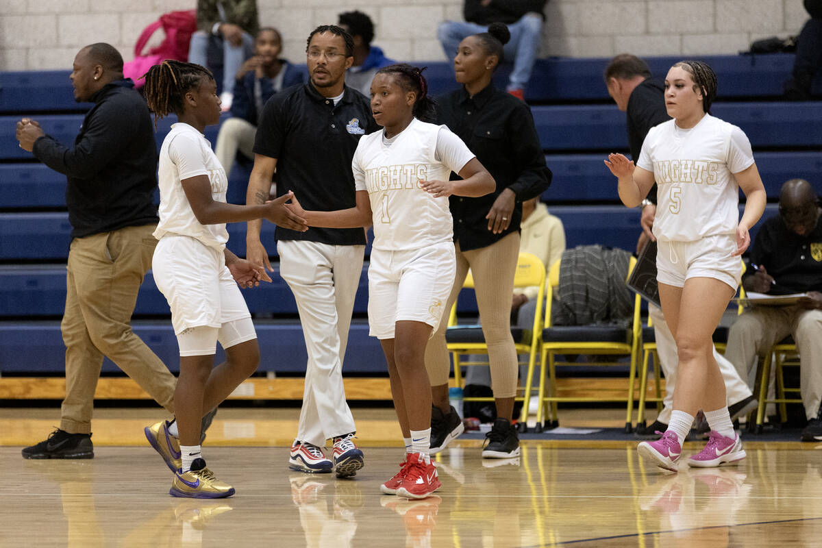 Democracy Prep’s Makiah Verdum (1) and Bray’ana Miles (3) slap hands during a gir ...