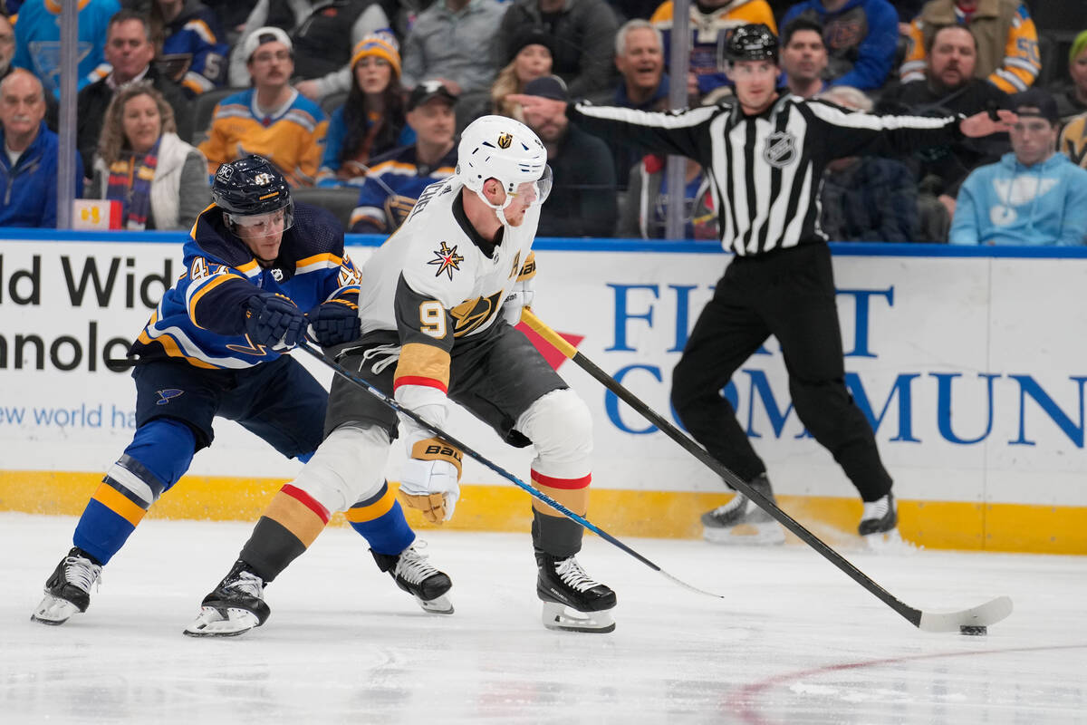 Vegas Golden Knights' Jack Eichel (9) and St. Louis Blues' Nick Leddy (4) battle for a loose pu ...