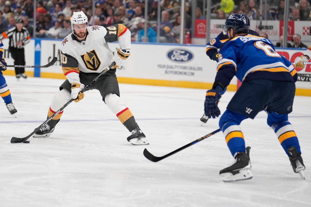 Vegas Golden Knights' Nicolas Roy (10) looks to pass around St. Louis Blues' Marco Scandella (6 ...