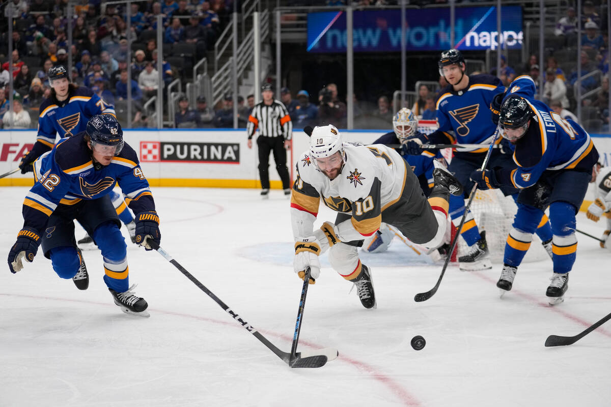 Vegas Golden Knights' Nicolas Roy (10) reaches for a loose puck as St. Louis Blues' Kasperi Kap ...