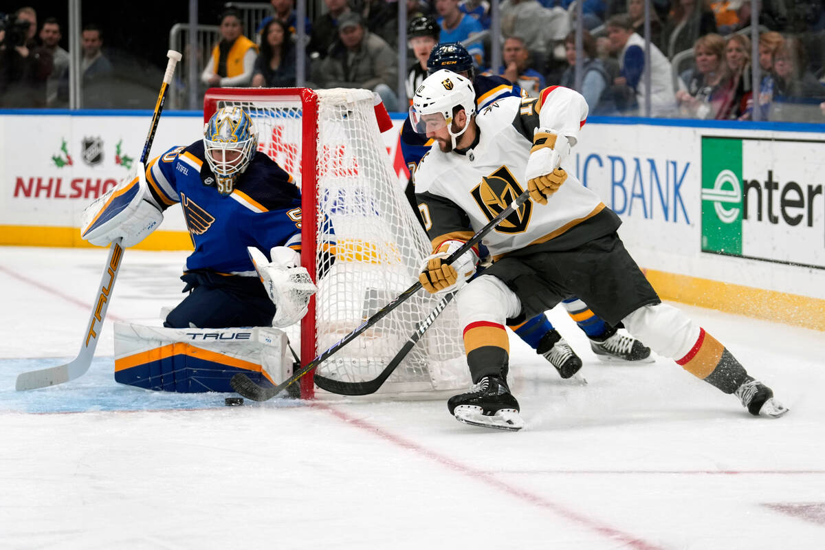 St. Louis Blues goaltender Jordan Binnington, left, blocks an attempt by Vegas Golden Knights' ...