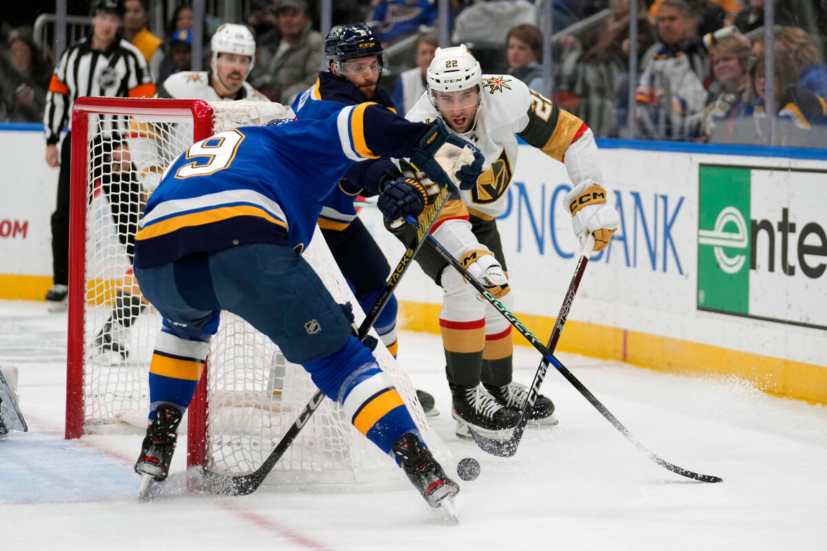 Vegas Golden Knights' Michael Amadio (22) passes around St. Louis Blues' Sammy Blais, left, dur ...