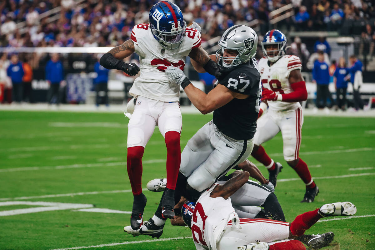 Raiders tight end Michael Mayer (87) takes New York Giants cornerback Cor'Dale Flott (28) down ...