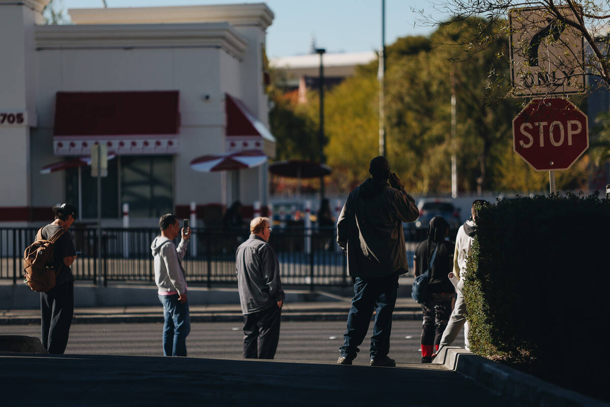 People make phone calls and film as police respond to a shooting on the UNLV campus on Wednesda ...