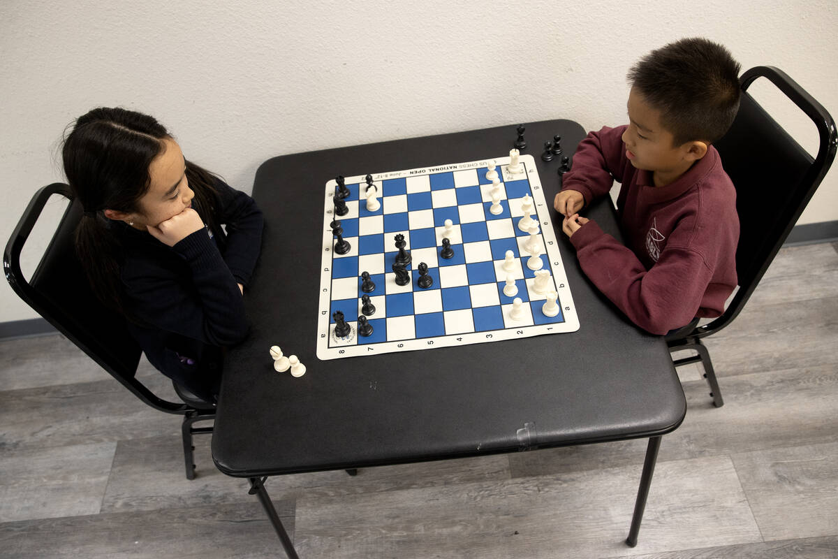 Julia Wang, 10, left, faces Timi Guo, 8, in a chess game before their lesson at Bridgeopolis on ...