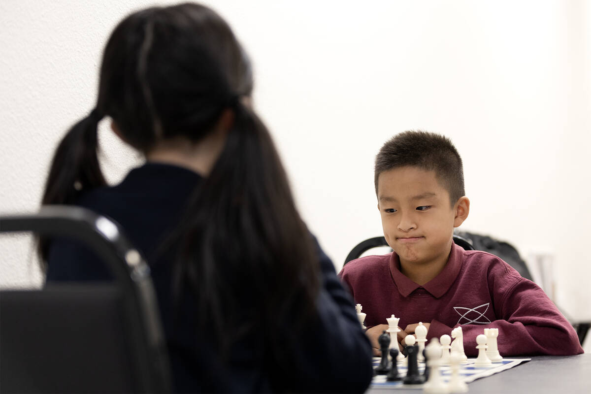 Timi Guo, 8, contemplates his next move during a chess match with Julia Wang, 10, at Bridgeopol ...