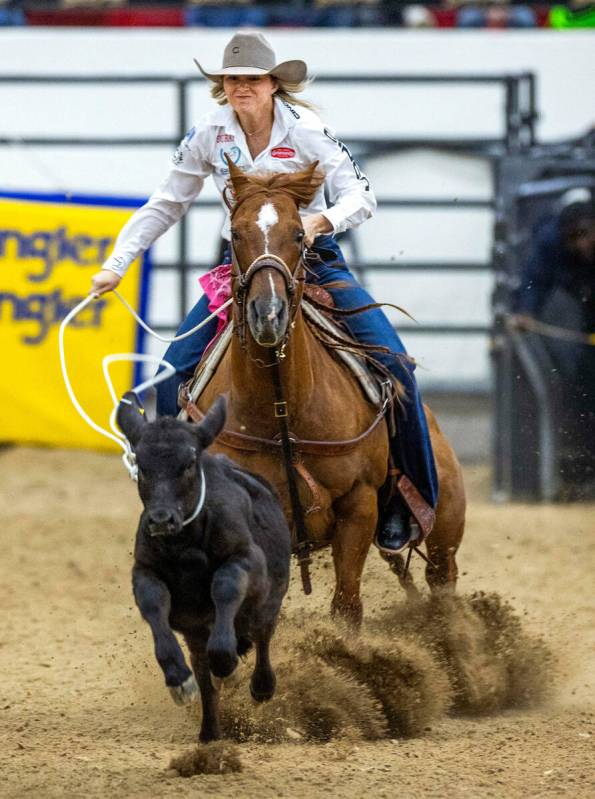 Cheyanne McCartney of Kingston, OK., ropes a calf during the NFR breakaway roping challenge at ...