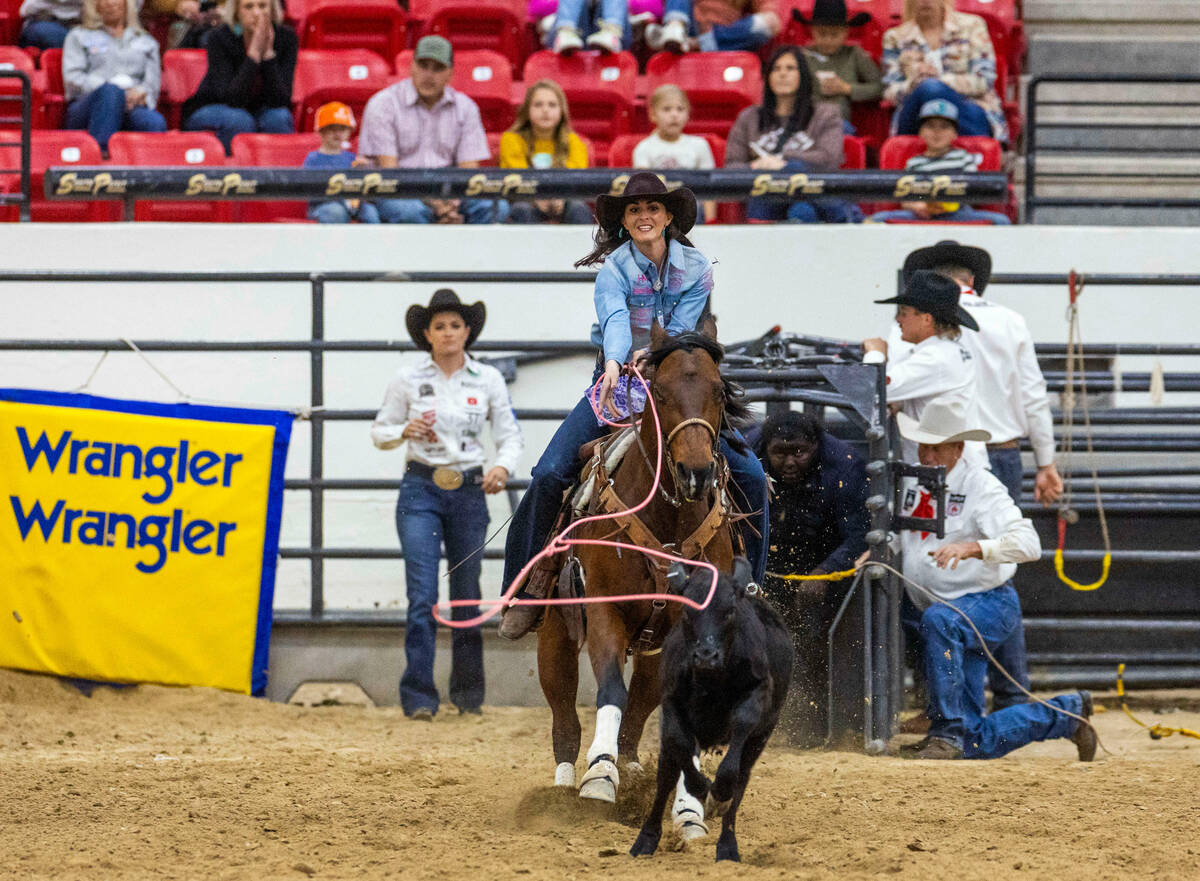 Joey Williams of Volborg, MT., aims to rope a calf during the NFR breakaway roping challenge at ...