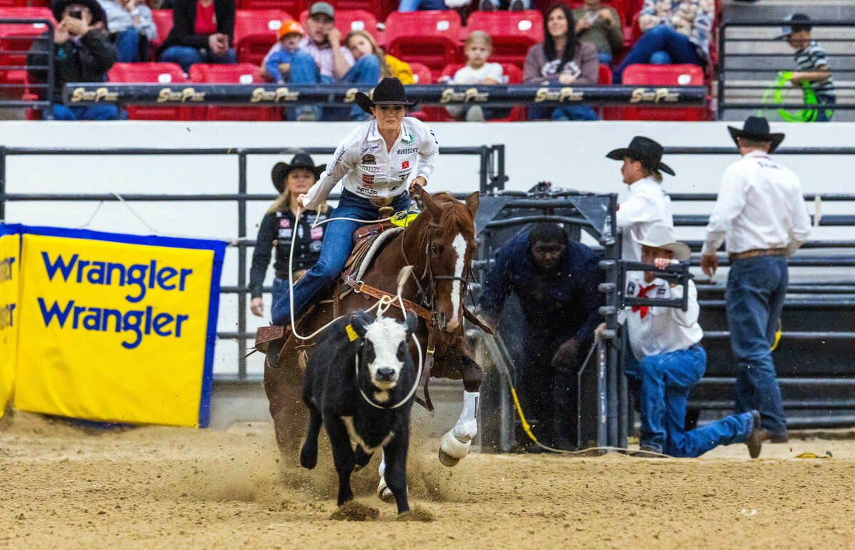 Shelby Boisjoli-Meged of Stephenville, Texas, ropes a calf during the NFR breakaway roping chal ...