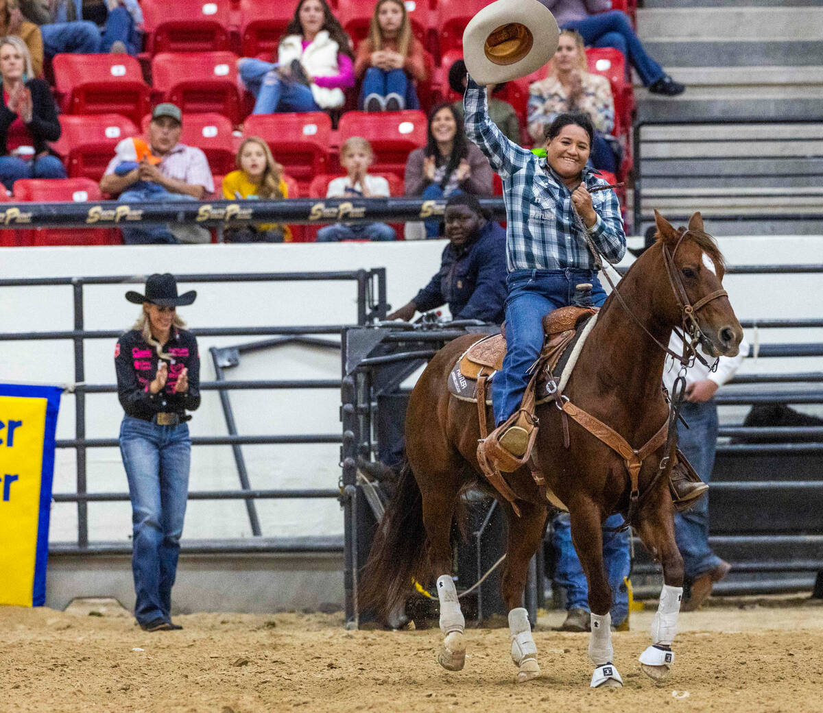 Danielle Lowman of Gilbert, AZ., waves to the crowd after a world record time during the NFR br ...