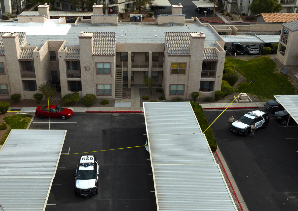 LVMPD vehicles are parked outside the residence of the man suspected in the deadly UNLV shootin ...