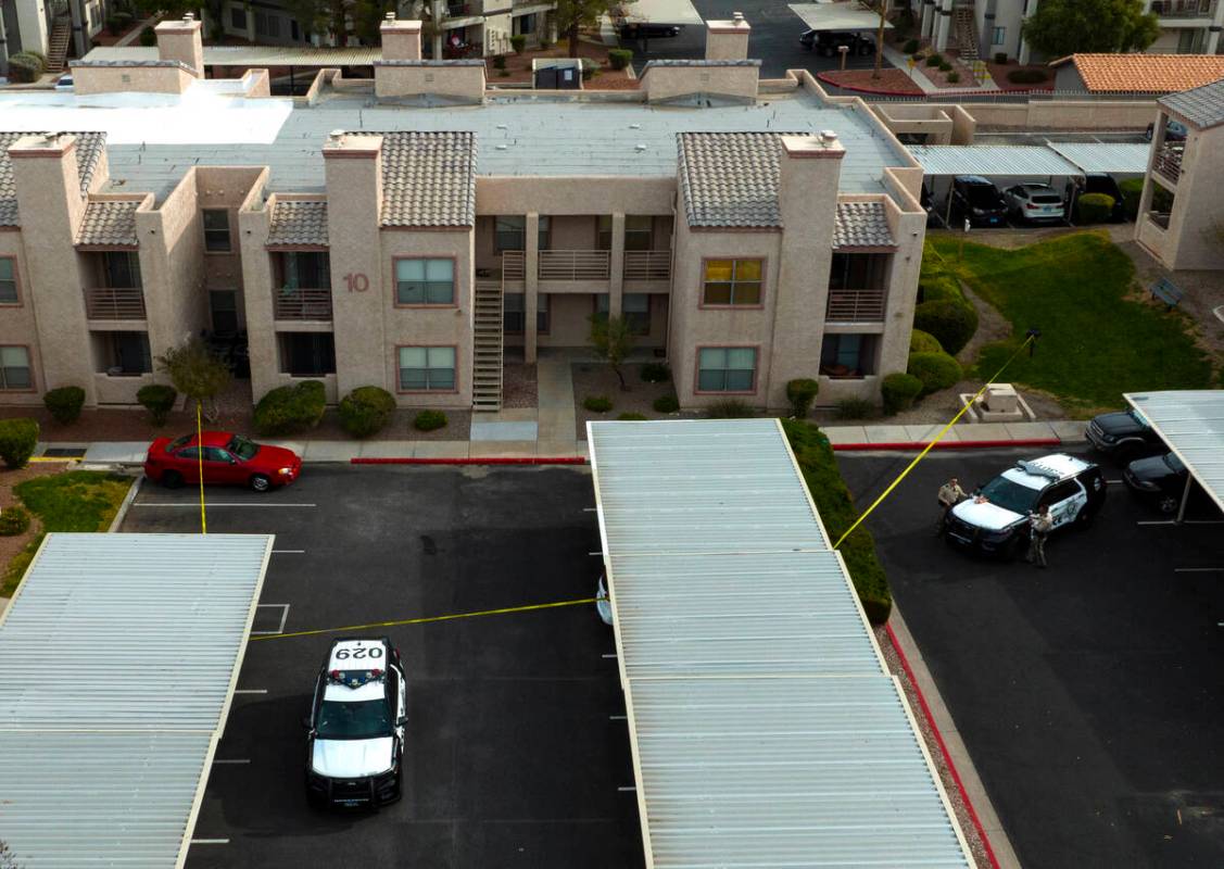 LVMPD vehicles are parked outside the residence of the man suspected in the deadly UNLV shootin ...