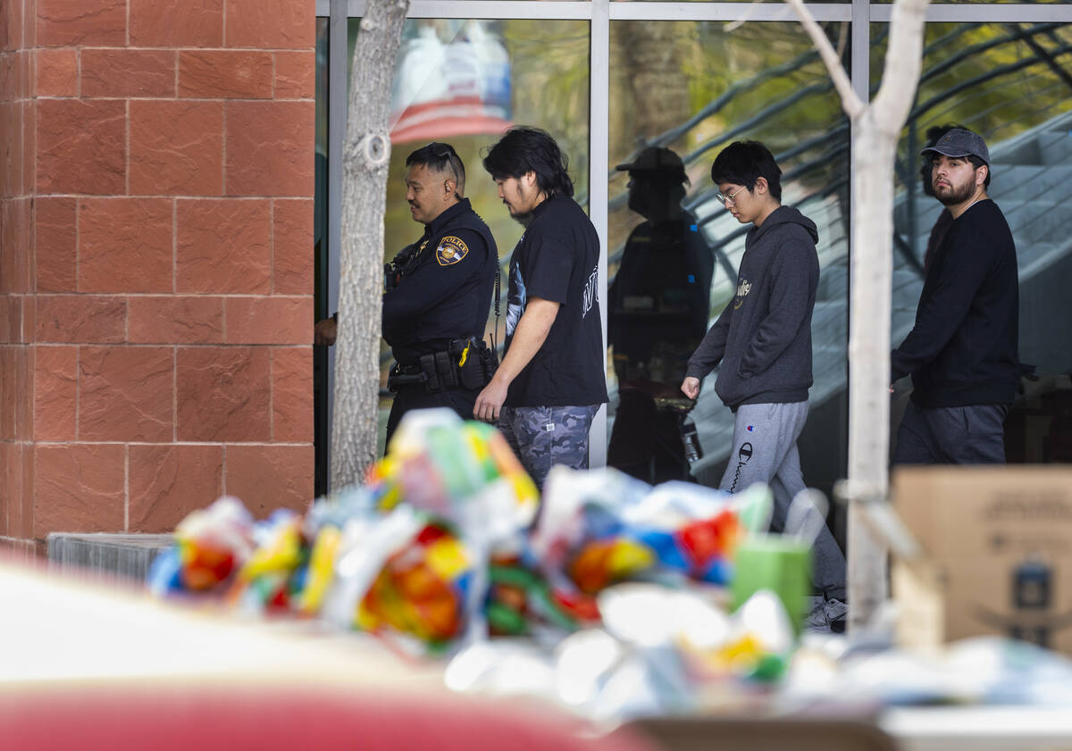 University Police escort people inside the Student Union following the shooting yesterday on t ...