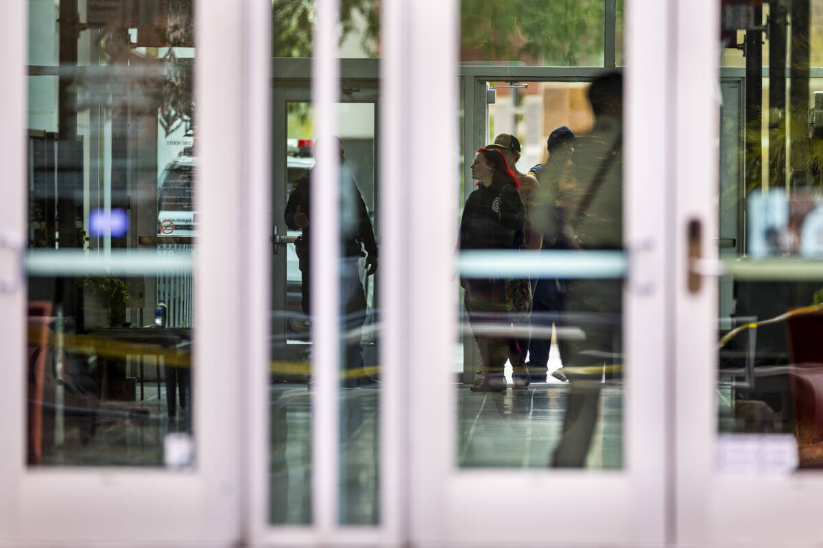 University Police escort people inside the Student Union following the shooting yesterday on t ...