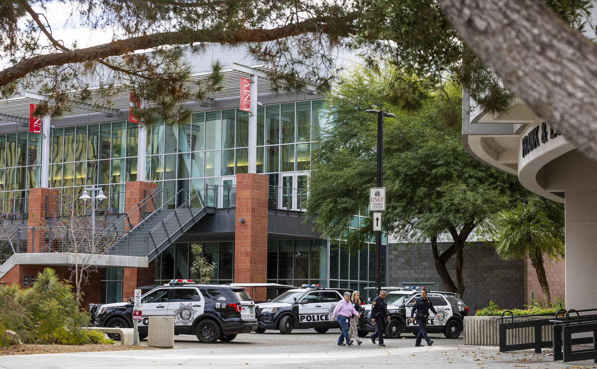 Clark County Coroner personnel with UNLV Police walk to the entrance to the Frank and Estella B ...