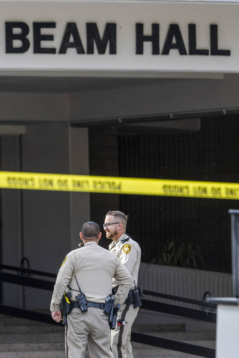 Metro officers stand near the entrance to the Frank and Estella Beam Hall following the shootin ...