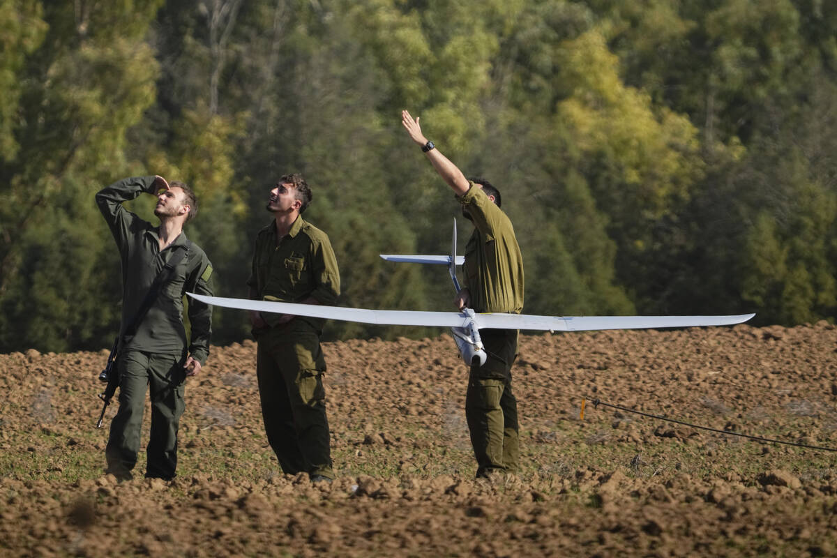 Israeli soldiers operate a drone near the Israeli-Gaza border, southern Israel, Wednesday, Dec. ...