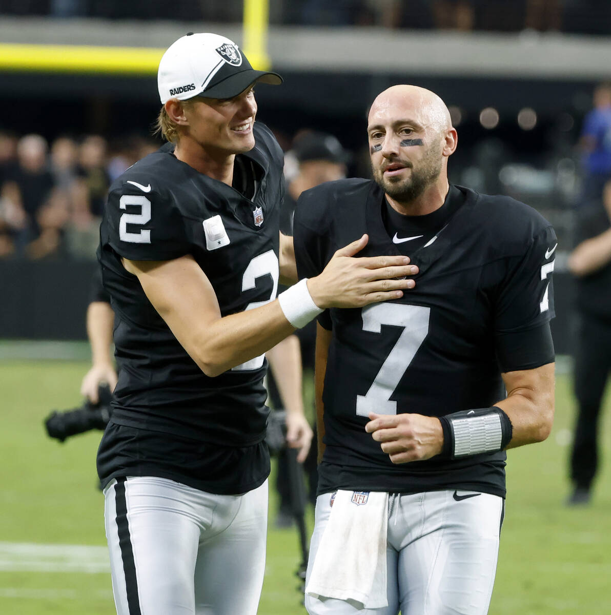 Raiders quarterback Brian Hoyer (7) and place kicker Daniel Carlson (2) leave the field after d ...