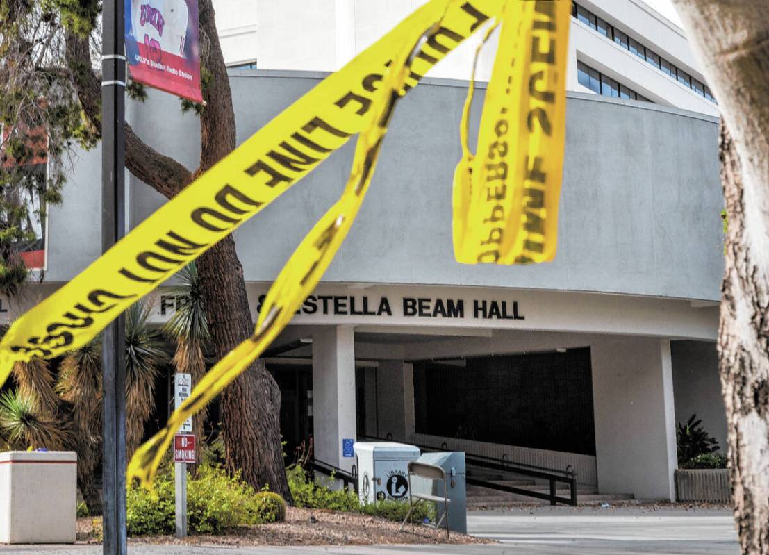 Police tape remains on a tree outside the entrance to the Frank and Estella Beam Hall following ...