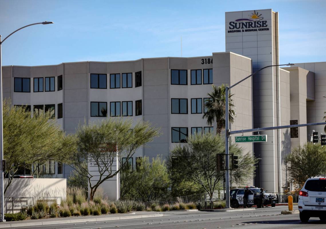 Police gather at Sunrise Hospital and Medical Center after a fatal shooting at UNLV, in Las Veg ...