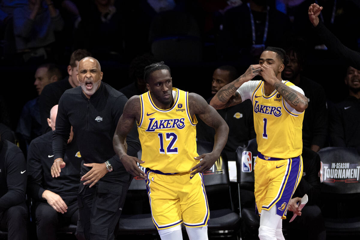 Los Angeles Lakers guard D'Angelo Russell (1) celebrates after scoring alongside head coach Dar ...