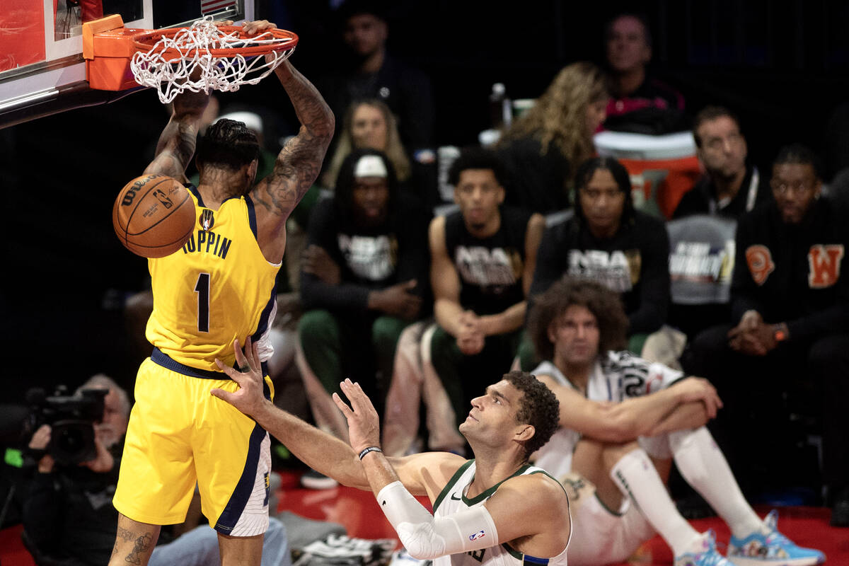 Indiana Pacers forward Obi Toppin (1) reverse dunks against Milwaukee Bucks center Brook Lopez ...