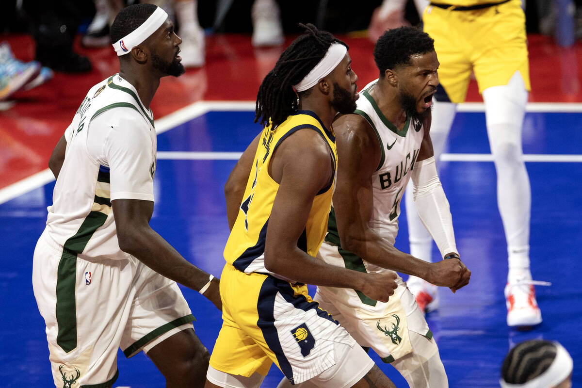 Milwaukee Bucks guard Malik Beasley (5) celebrates after scoring on Indiana Pacers forward Isai ...