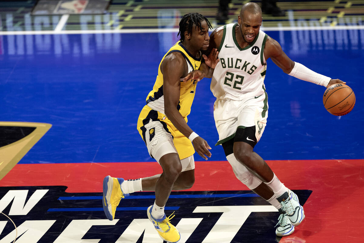 Milwaukee Bucks forward Khris Middleton (22) dribbles against Indiana Pacers forward Aaron Nesm ...