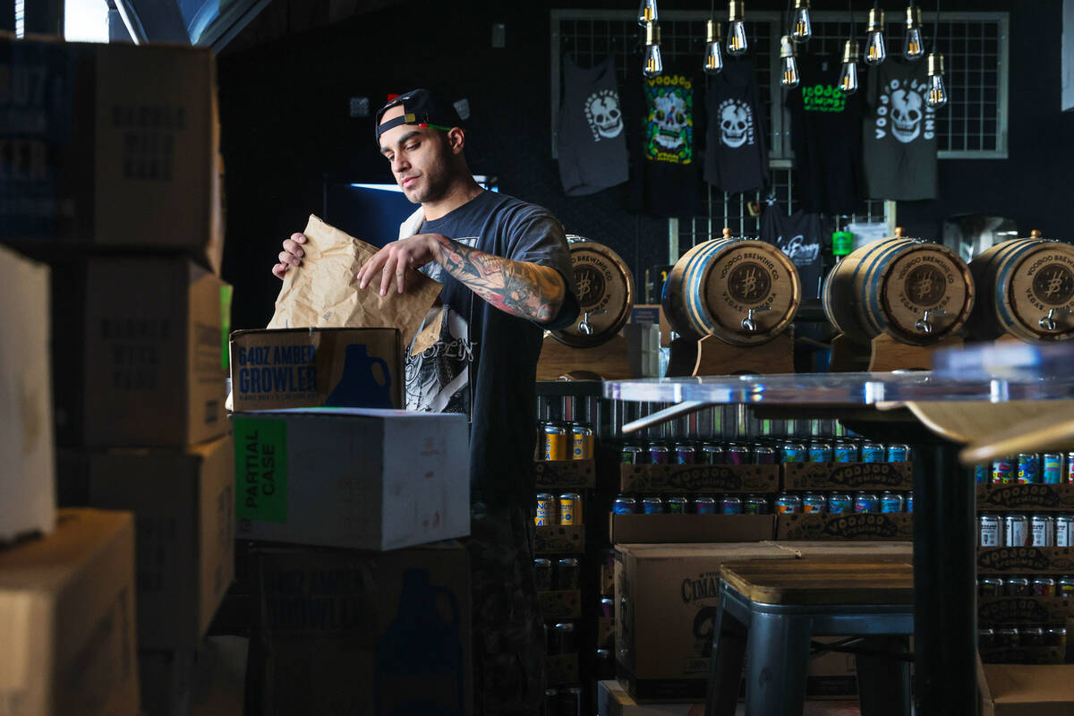 General Manager Austin Gallucci works on tasks to prepare for the opening of Voodoo Brewing in ...