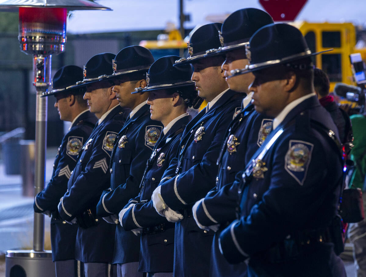 An honor guard stands before family members during a candlelight vigil for Nevada Highway Patro ...