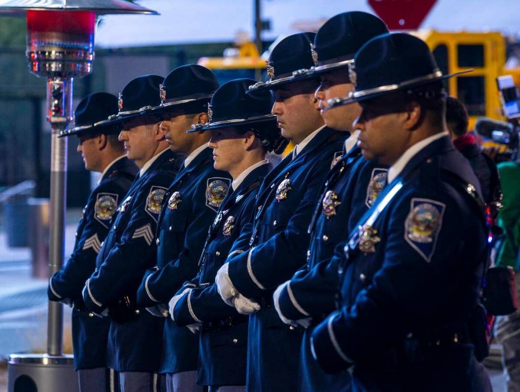 An honor guard stands before family members during a candlelight vigil for Nevada Highway Patro ...