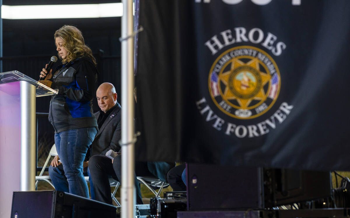 Christa Swanger, widow of Officer Jason Swanger, gives an opening prayer during a candlelight v ...