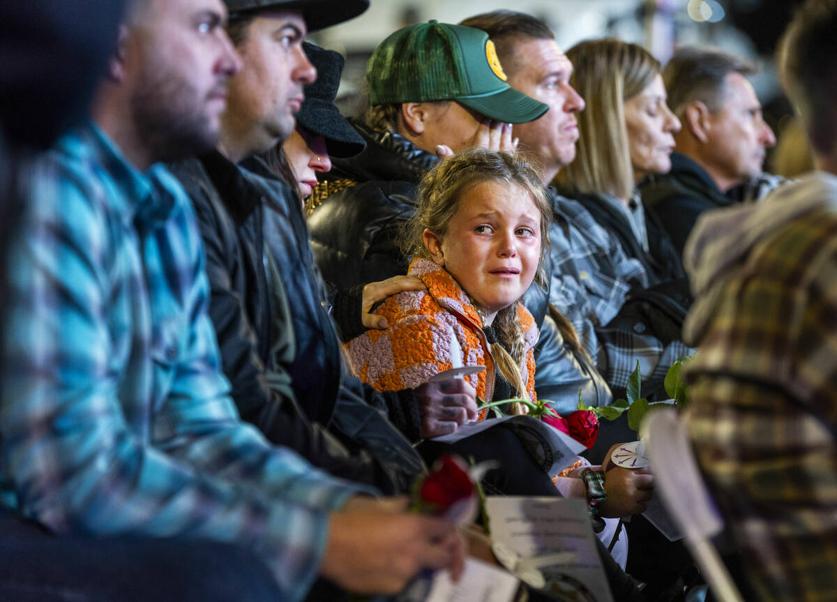 A young mourner sheds a few tears while amongst others during a candlelight vigil for Nevada Hi ...