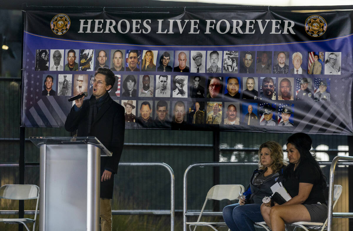 Singer Connor Nicholas performs "Homeward Bound" during a candlelight vigil for Nevad ...