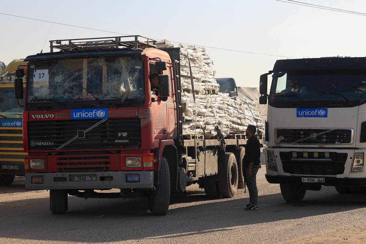 Trucks carrying humanitarian aid enter the Gaza Strip via the Rafah crossing with Egypt on Dec. ...