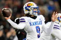 Kansas quarterback Jason Bean (9) prepares to throw a pass against Cincinnati during an NCAA co ...