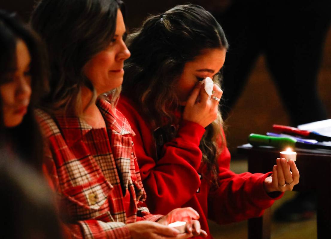 People mourn at a community prayer held for the victims of the Dec. 6 UNLV shooting, hosted at ...