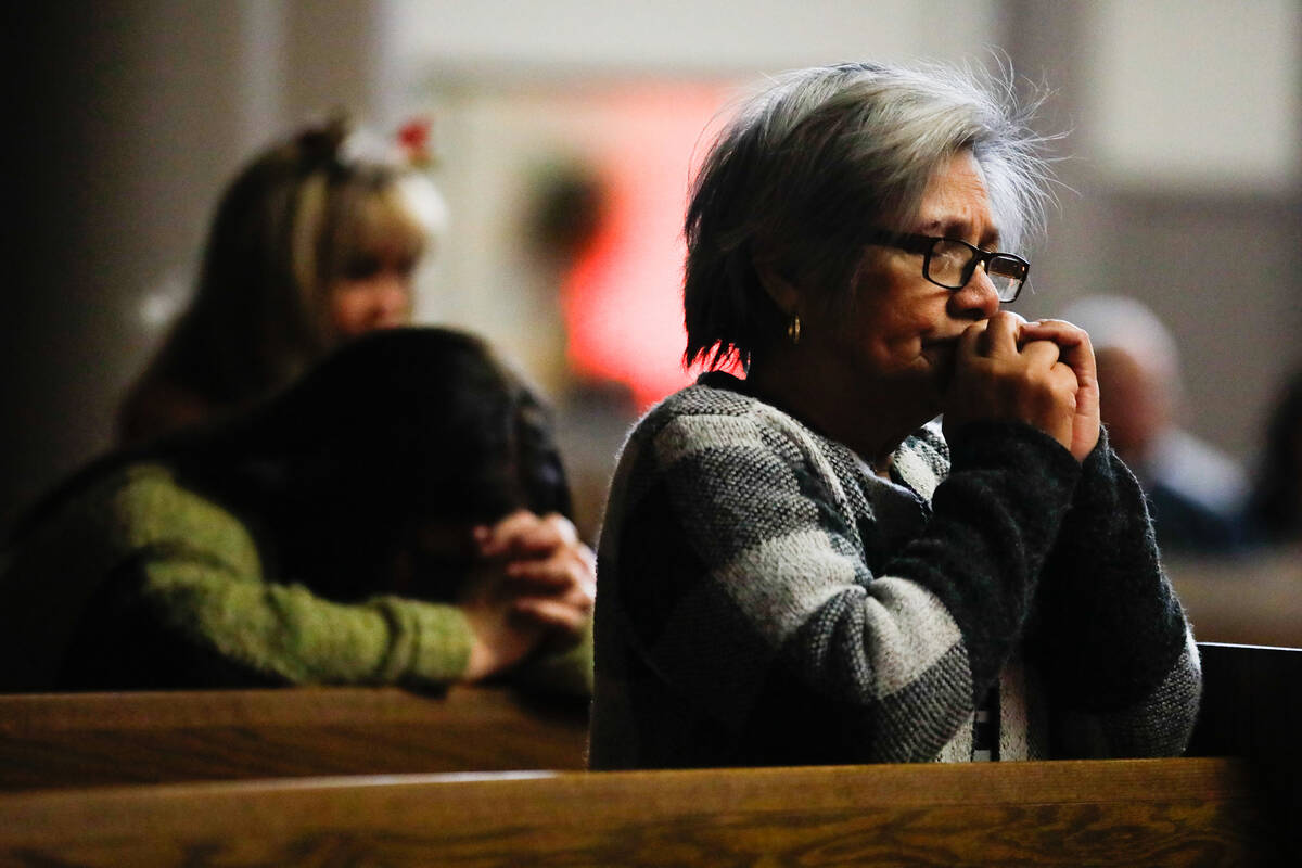 People mourn at a community prayer held for the victims of the Dec. 6 UNLV shooting, hosted at ...