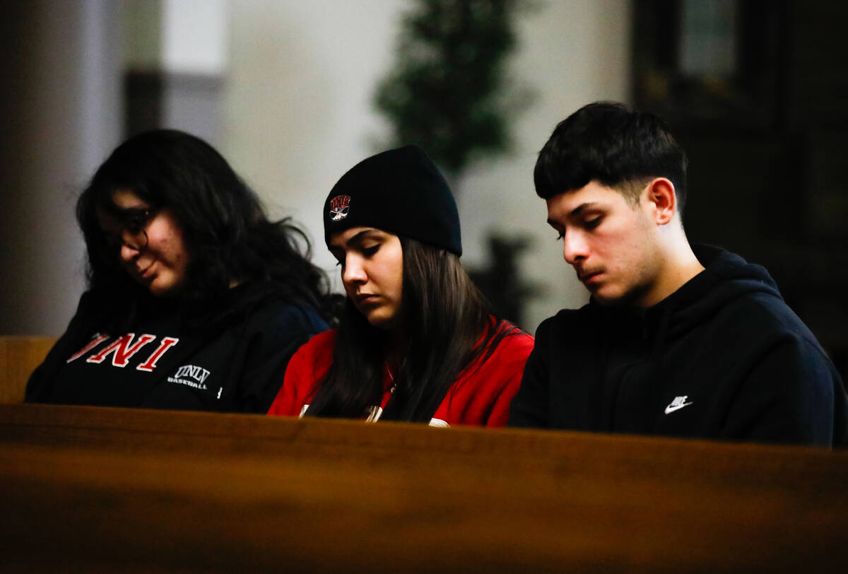 People mourn at a community prayer held for the victims of the Dec. 6 UNLV shooting, hosted at ...