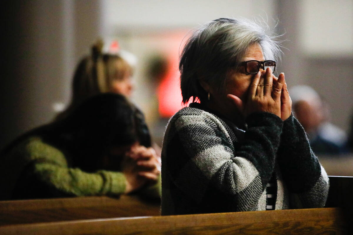 People mourn at a community prayer held for the victims of the Dec. 6 UNLV shooting, hosted at ...