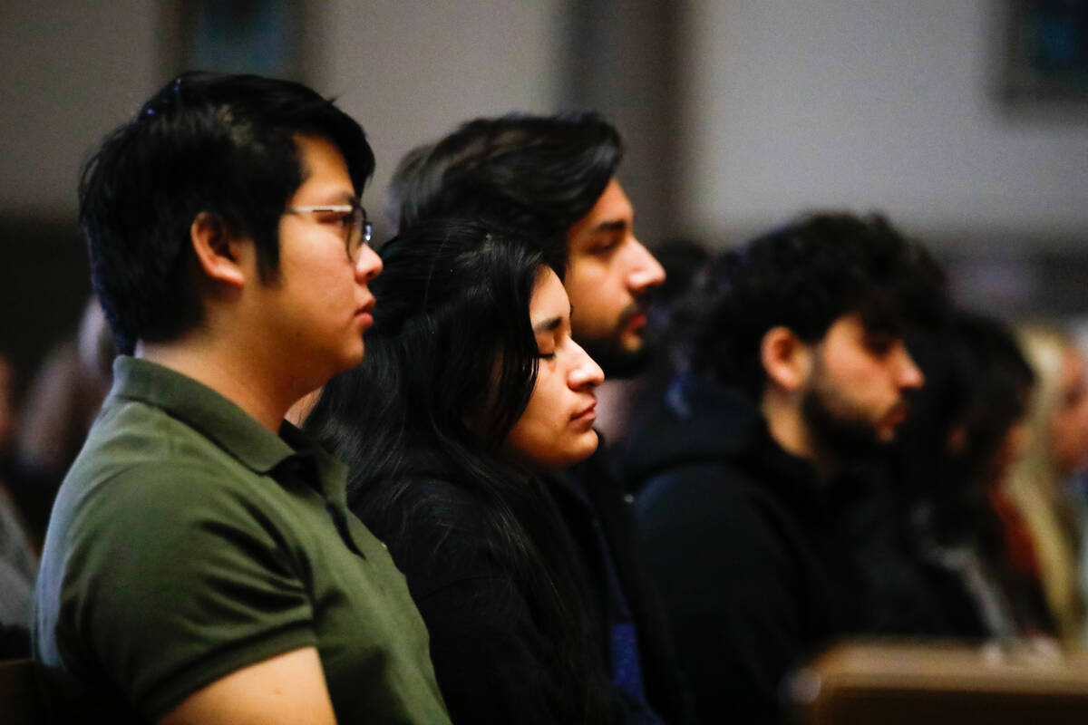 People mourn at a community prayer held for the victims of the Dec. 6 UNLV shooting, hosted at ...