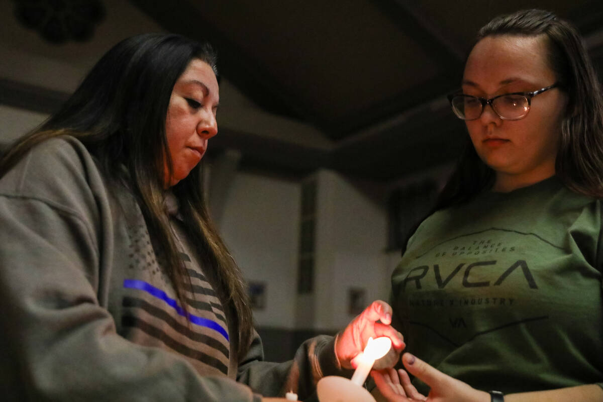 People mourn at a community prayer held for the victims of the Dec. 6 UNLV shooting, hosted at ...