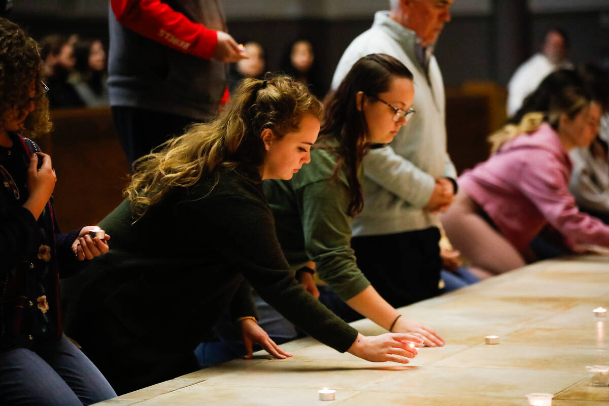 People mourn at a community prayer held for the victims of the Dec. 6 UNLV shooting, hosted at ...