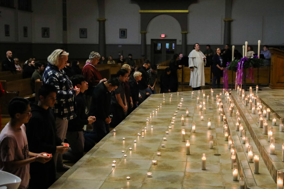 People mourn at a community prayer held for the victims of the Dec. 6 UNLV shooting, hosted at ...