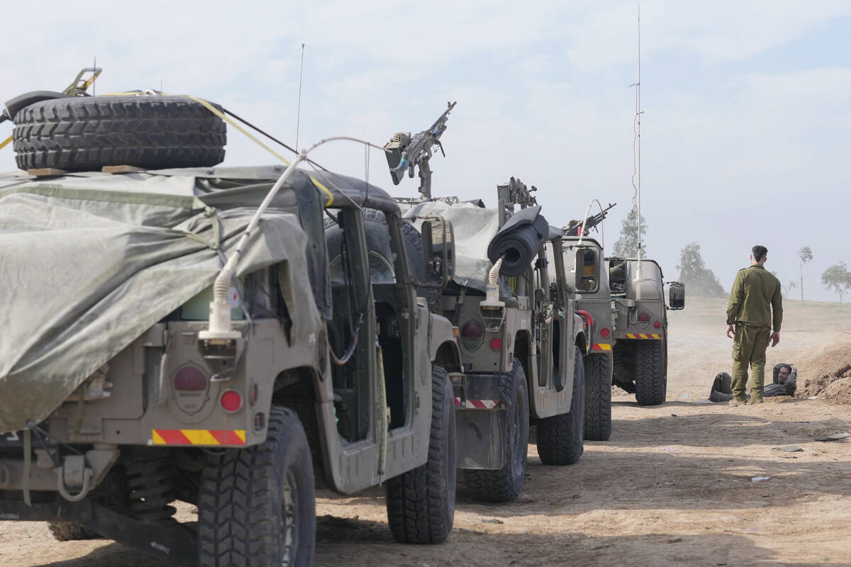 Israeli soldiers gather near the border with the Gaza Strip, southern Israel, Friday, Dec. 8, 2 ...