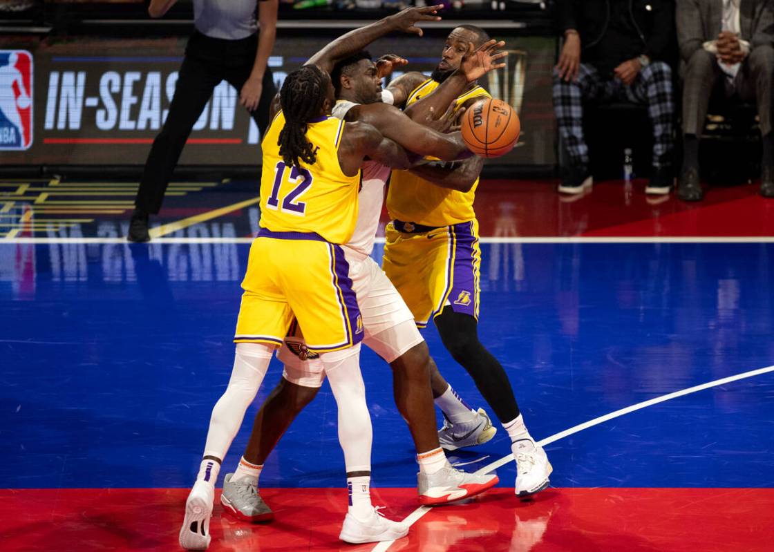 New Orleans Pelicans forward Zion Williamson (1) is surrounded by Los Angeles Lakers forward Ta ...